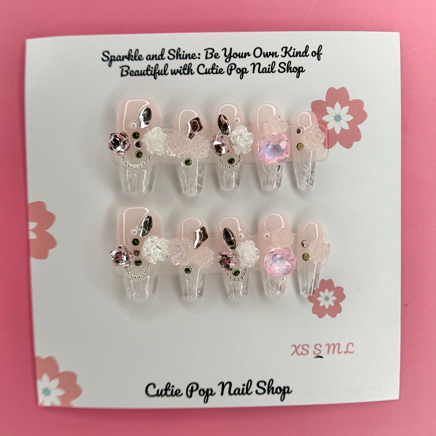 Elegant Rose (Pink) press on nails by CutiePop Nail Shop featuring medium coffin shaped nails in soft pink tones, adorned with delicate rose art and elegant floral accents. Designed for a classy and romantic look, perfect for adding a touch of timeless charm to any outfit.