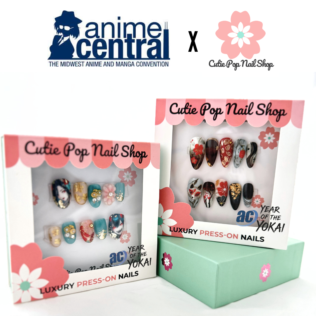 Anime Central – Kitsune press on nails by CutiePop Nail Shop featuring medium round shaped nails with anime-inspired fox art and red floral accents. This design blends traditional Japanese kitsune motifs with modern nail aesthetics for a bold and mystical look.