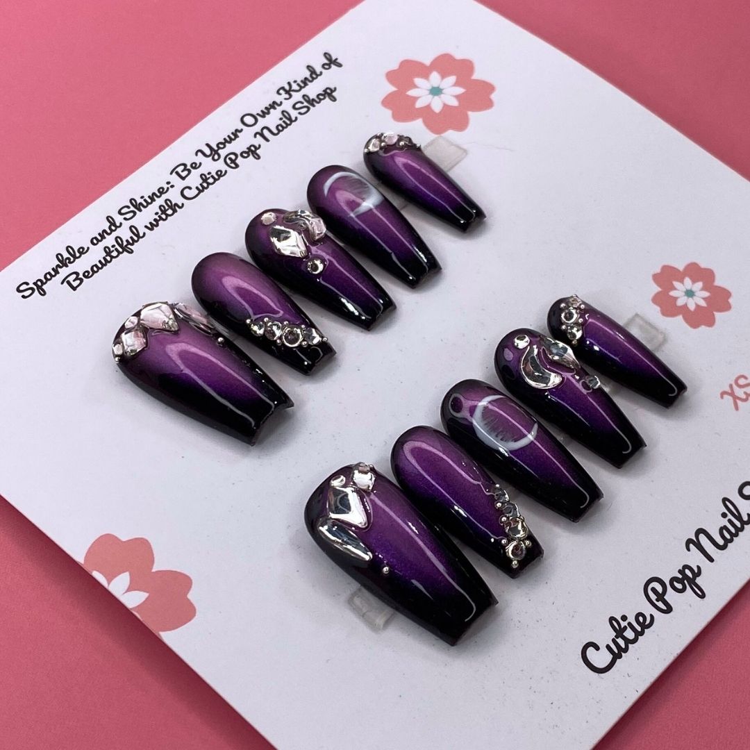 Golden Lady press-on nails by CutiePop Nail Shop featuring medium-length coffin-shaped nails in elegant nude and gold tones. Accented with fine glitter, metallic details, and a glossy finish, this set exudes a luxurious, feminine aesthetic perfect for special occasions or a glam everyday look. Includes 10 reusable handmade nails, jelly adhesive tabs, a mini nail file, and a cuticle stick for easy application.