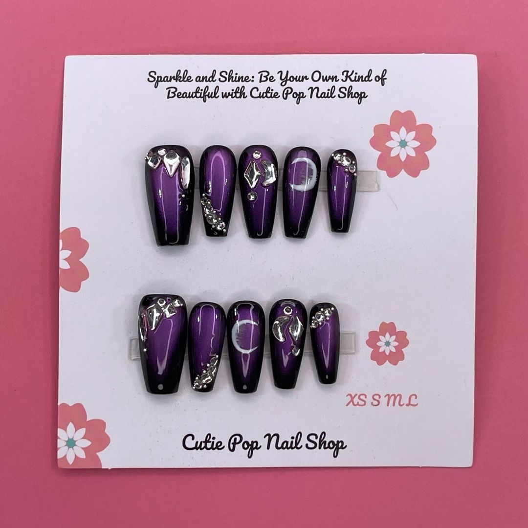 Golden Lady press-on nails by CutiePop Nail Shop featuring medium-length coffin-shaped nails in elegant nude and gold tones. Accented with fine glitter, metallic details, and a glossy finish, this set exudes a luxurious, feminine aesthetic perfect for special occasions or a glam everyday look. Includes 10 reusable handmade nails, jelly adhesive tabs, a mini nail file, and a cuticle stick for easy application.