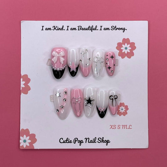 Bloom Coquette press on nails by CutiePop Nail Shop featuring round shaped nails in soft pink tones with floral designs, pearl accents, and a flirty coquette-inspired aesthetic.