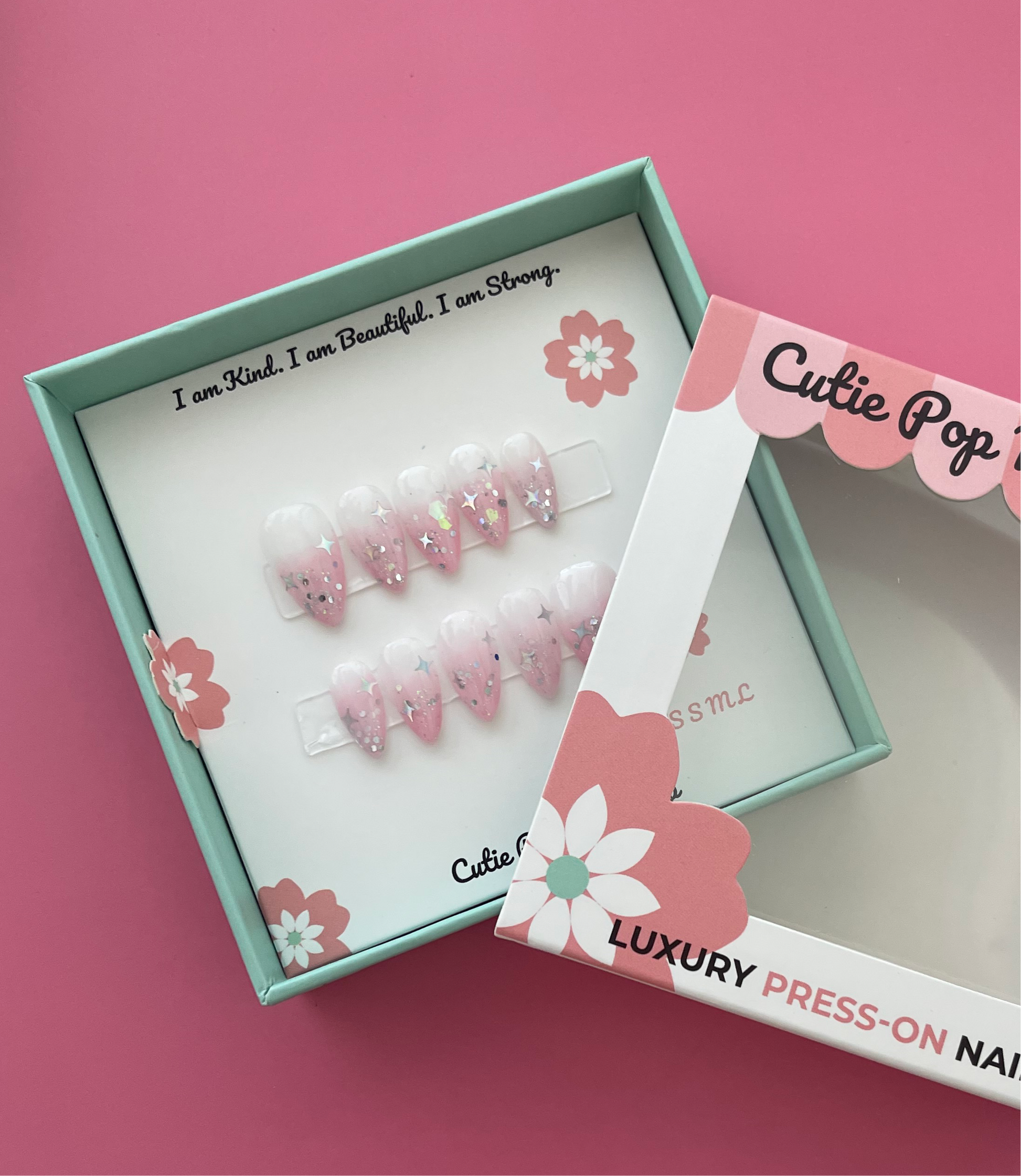 Fantasy (Blush Pink) press‑on nails by CutiePop Nail Shop featuring short to medium-length almond-shaped nails with a dreamy blush‑pink syrup jelly gel polish. The sheer gradient finish reflects light like a soft glow, creating an ethereal, fantasy-inspired aesthetic. Includes a reusable kit with ten handmade nails, jelly adhesive tabs, a mini nail file, and a cuticle stick—perfect for a subtle, enchanting manicure.