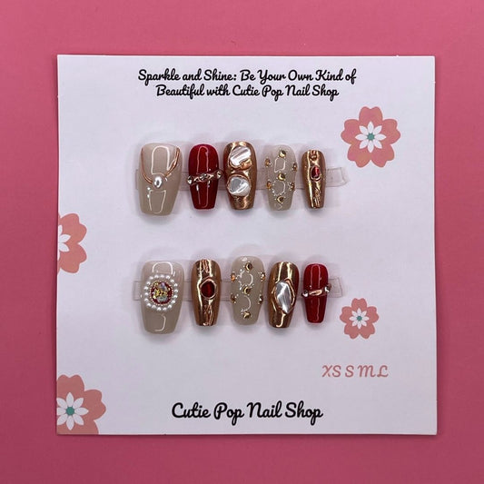 Cleopatra press on nails by CutiePop Nail Shop featuring medium coffin shaped nails in bold gold and black tones with Egyptian-inspired patterns, metallic accents, and a regal, luxurious vibe.