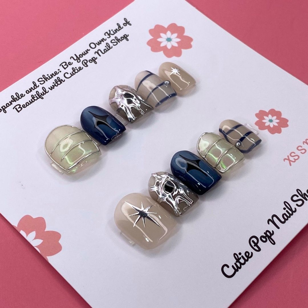 Mythical Dream press on nails by CutiePop Nail Shop featuring short squoval shaped nails in dreamy pastel tones with fantasy-inspired elements like stars, moons, and subtle shimmer for a soft, magical look.