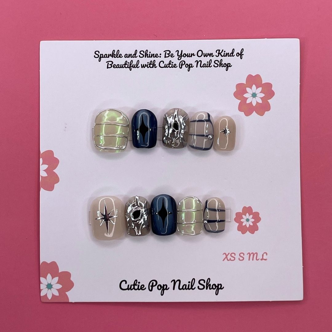 Mythical Dream press on nails by CutiePop Nail Shop featuring short squoval shaped nails in dreamy pastel tones with fantasy-inspired elements like stars, moons, and subtle shimmer for a soft, magical look.