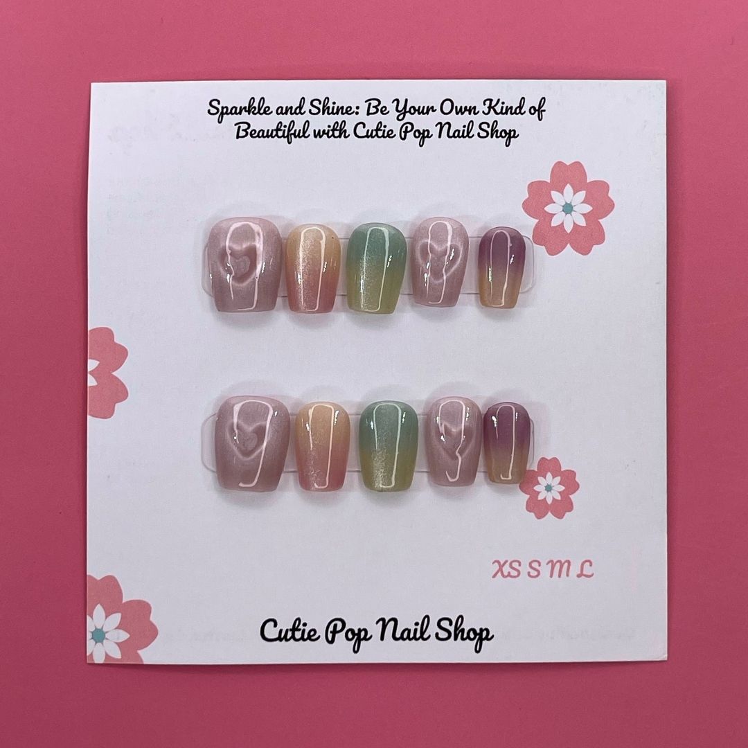 Pastel Holo press-on nails by CutiePop Nail Shop feature extra-short square-shaped nails in soft pastel hues with a mesmerizing holographic finish. This dreamy, iridescent design adds a subtle yet magical glow to your everyday look. Each kit includes 10 reusable handmade nails, jelly adhesive tabs, a mini nail file, and a cuticle stick.