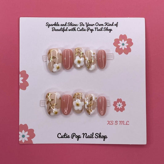 Spring Flowers press-on nails by CutiePop Nail Shop featuring medium-length round-shaped nails in soft pastel tones, adorned with hand-painted floral designs, pearl or gem accents, and a fresh, springtime aesthetic perfect for a cheerful, blooming look.