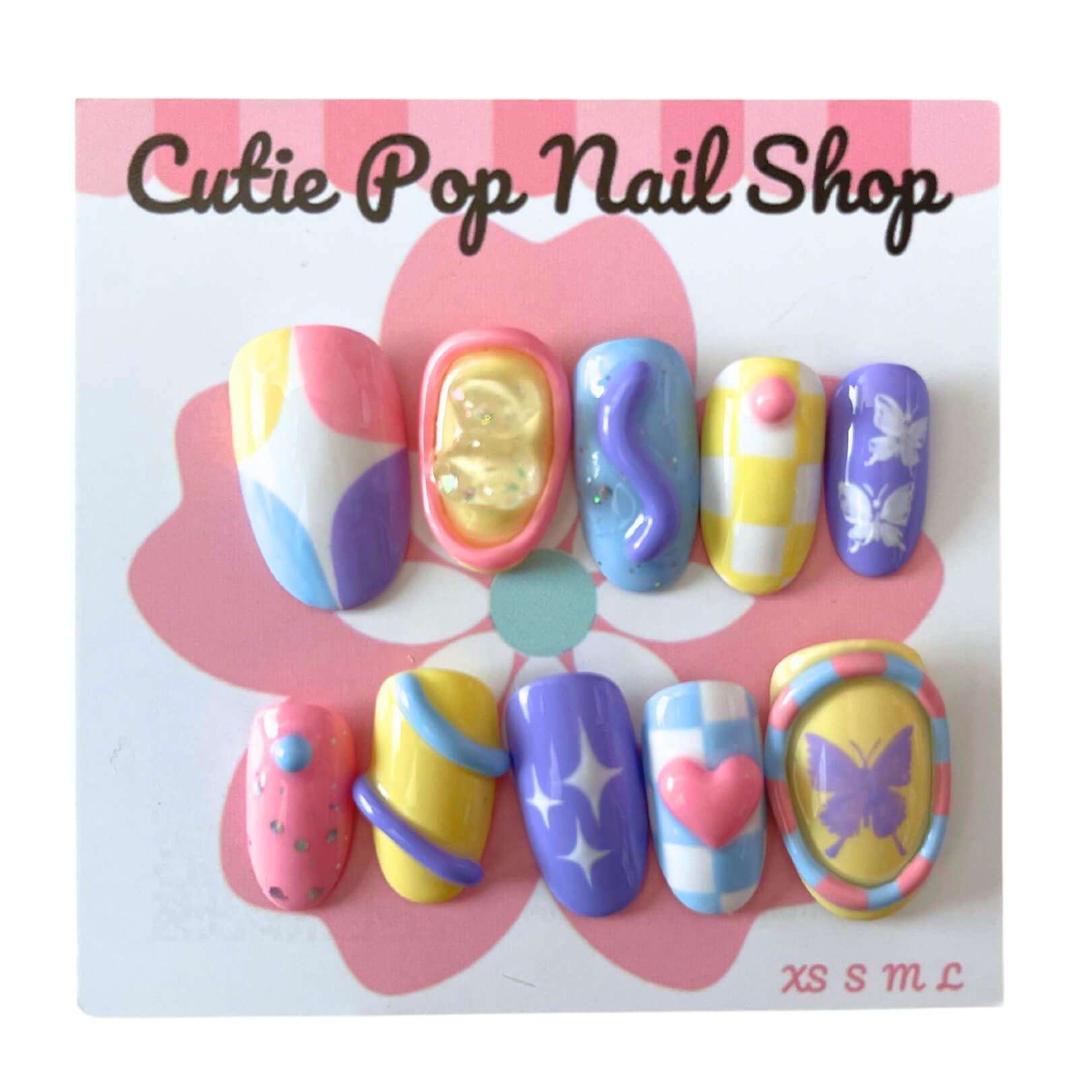 Twinkling Butterflies press‑on nails by CutiePop Nail Shop featuring round-shaped, short-length nails in pastel hues of lavender, mint, and baby pink, decorated with whimsical hand-painted butterflies, hearts atop a subtle checkered background, and delicate glitter sparkles. Includes reusable adhesive tabs, mini nail file, and cuticle stick in the kit—offering a fantasy-inspired, playful, and elegant manicure.