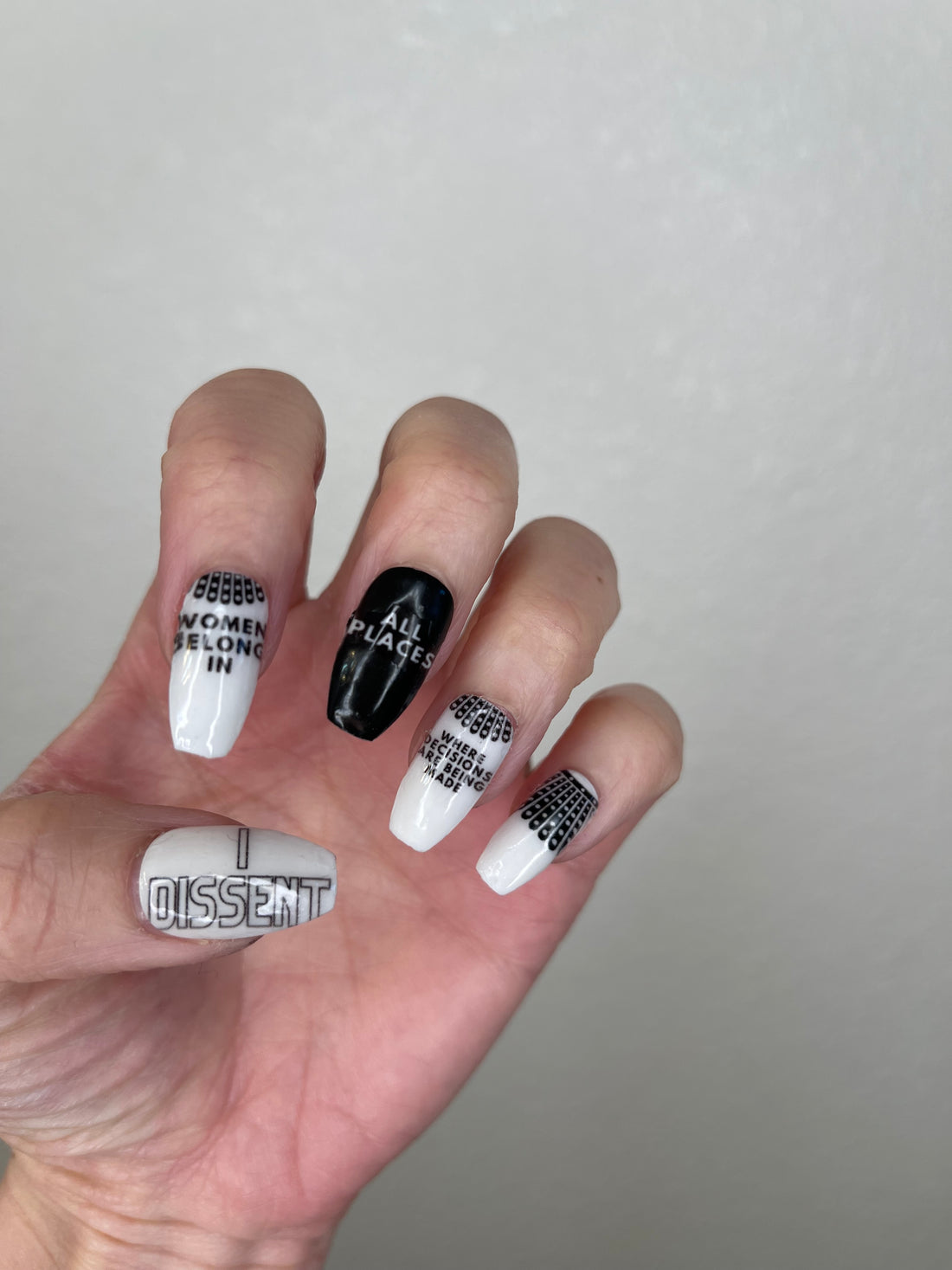 Trailblazers nail stickers by Cutie Pop Nail Shop featuring hand-drawn portraits of iconic women alongside empowering phrases like “You can do this,” “We belong in all places,” and “Strength” in bold and pastel colors arranged on a pink edged display card labeled "Easy Peel & Apply Nail Stickers."