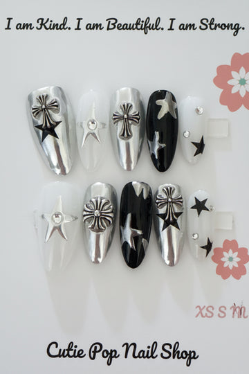 Y2K Kpop Silver Black Star press-on nails in silver and black with a glossy finish, featuring star-shaped designs and edgy rockstar-inspired 3D accents – displayed on a Cutie Pop Nail Shop card.