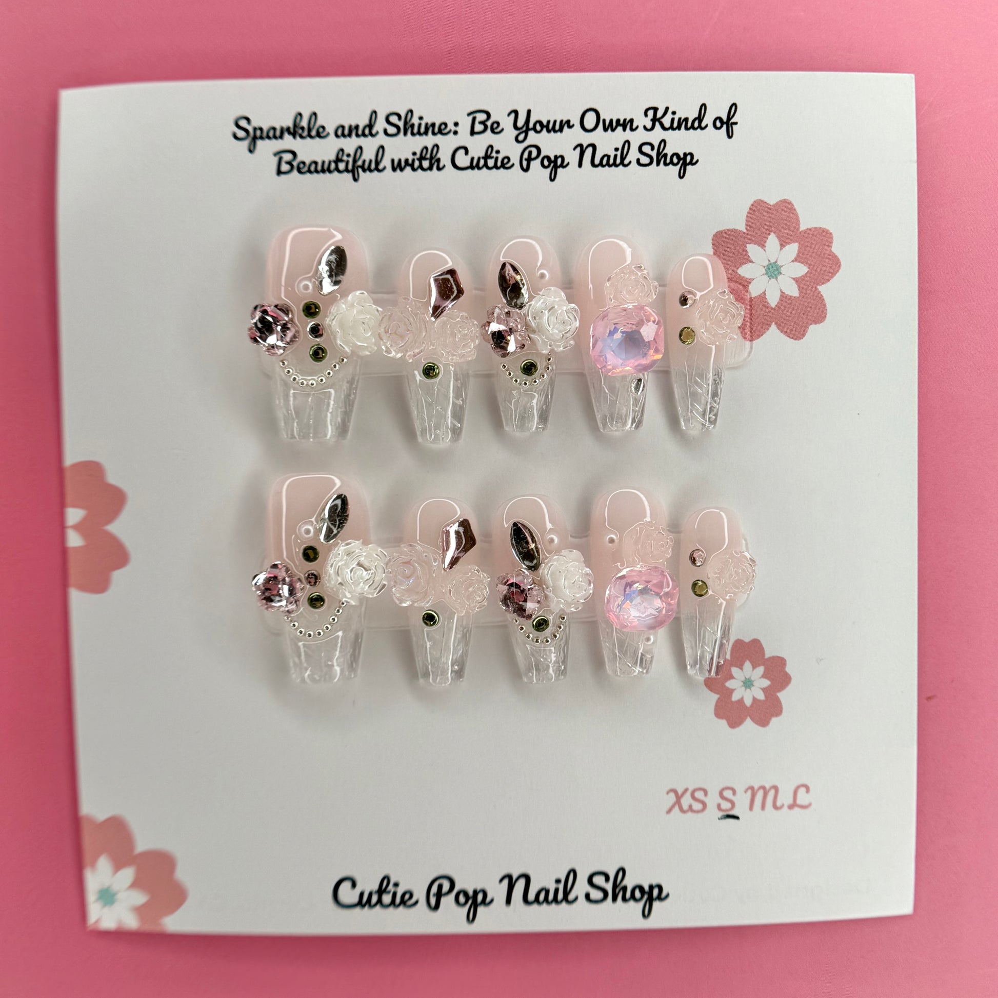 Elegant Rose (Pink) press on nails by CutiePop Nail Shop featuring medium coffin shaped nails in soft pink tones, adorned with delicate rose art and elegant floral accents. Designed for a classy and romantic look, perfect for adding a touch of timeless charm to any outfit.

