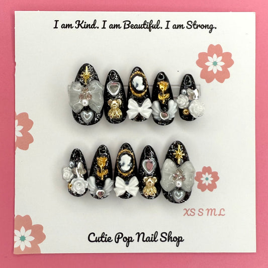 Victorian Shadows press-on nails by CutiePop Nail Shop featuring medium-length coffin-shaped nails with a gothic-inspired design. Showcasing intricate dark tones, lace-like patterns, and elegant vintage accents for a moody, romantic aesthetic.

