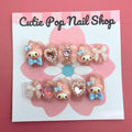 Bunny Pink Bow press on nails by CutiePop Nail Shop featuring short or medium coffin shaped nails in soft pink tones, adorned with adorable bunny motifs, dainty bow accents, and subtle glitter details. Designed for a sweet, playful look with a kawaii charm. Includes a full DIY kit with 10 reusable handmade nails, jelly adhesive tabs, a mini nail file, and a cuticle stick.

