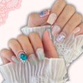 Moon Prism press‑on nails by CutiePop Nail Shop featuring medium-length square-shaped nails with a sheer, pastel pink-to-lavender jelly gradient and iridescent holographic sparkle. Accented with delicate hand‑placed star glitter, tiny crescent moon charms, and subtle metallic flake shimmer—delivering a dreamy, celestial-inspired manicure perfect for magical girl or Y2K aesthetic lovers. Kit includes ten reusable nails, adhesive tab sheet, a mini nail file, and a cuticle stick.