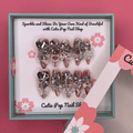 Bougie Bling 14 press on nails by CutiePop Nail Shop featuring long stiletto shaped nails with a dramatic glossy black base adorned with sparkling silver glitter accents and glamorous oversized 3D gem clusters in clear, smoke, and metallic tones, meticulously arranged for a bold, luxurious statement manicure.