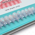 Fantasy (Lavender) press‑on nails by CutiePop Nail Shop featuring short-to-medium length almond-, round-, or coffin-shaped nails coated in dreamy lavender syrup jelly gel polish. Each nail is sprinkled with holographic star sequin glitter for a celestial shimmer effect. The set includes ten handmade reusable nails, jelly adhesive tabs, a mini nail file, and a cuticle stick—offering a whimsical, fantasy-inspired manicure perfect for summer enchantment.