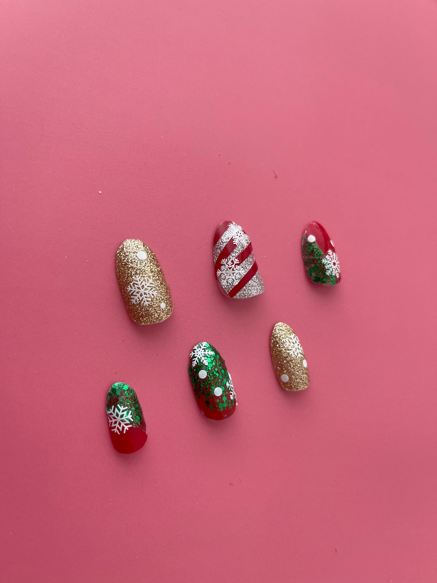 christmas nails in gold, red, green , silver glitter with snowflakes
