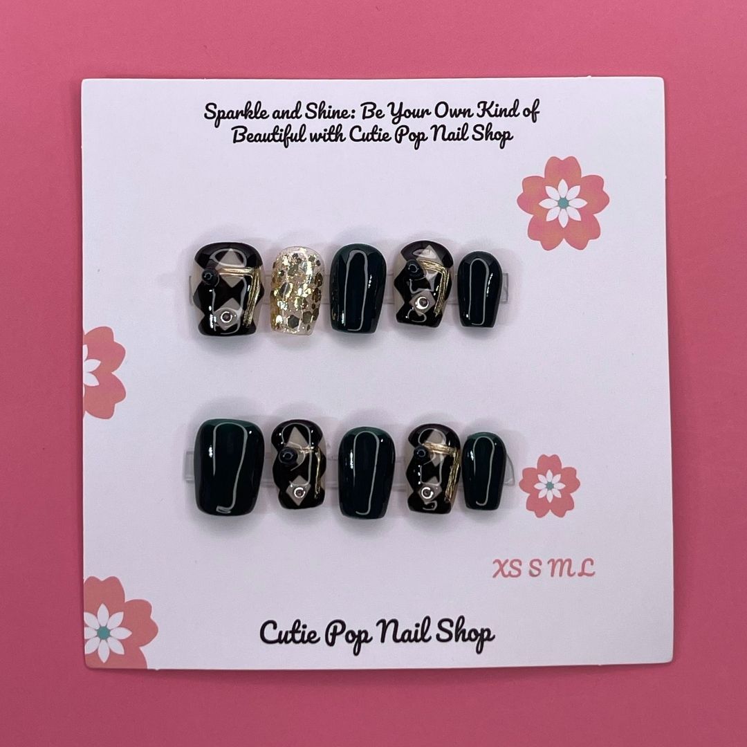 Classy Harlequinn press on nails by CutiePop Nail Shop featuring short squoval shaped nails with a sophisticated harlequin diamond pattern in black and white, accented with gold studs and a glossy finish—offering an elegant, timeless twist on a classic design.

