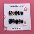 Classy Harlequinn press on nails by CutiePop Nail Shop featuring short squoval shaped nails with a sophisticated harlequin diamond pattern in black and white, accented with gold studs and a glossy finish—offering an elegant, timeless twist on a classic design.

