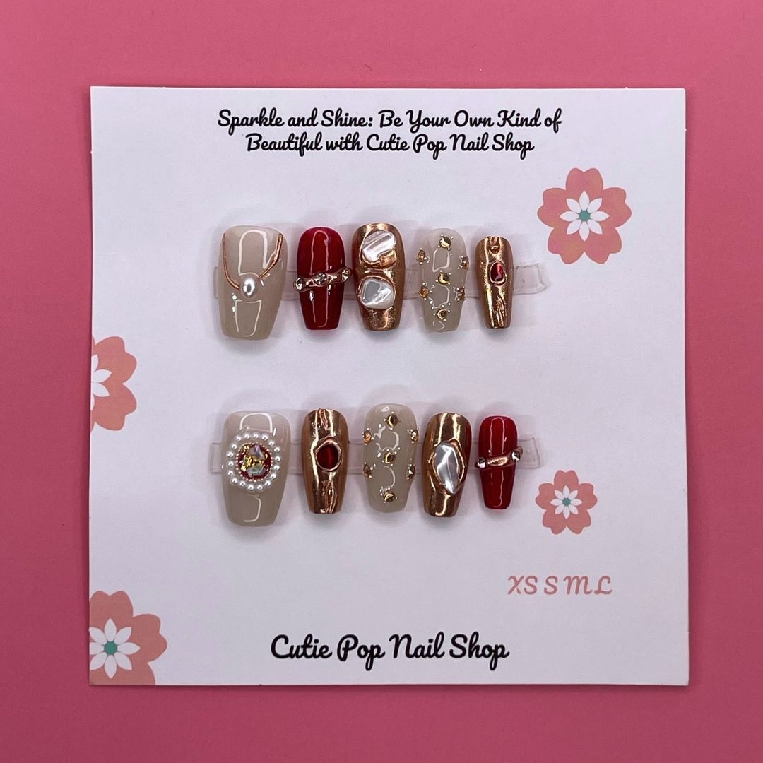 Cleopatra press on nails by CutiePop Nail Shop featuring medium coffin shaped nails in bold gold and black tones with Egyptian-inspired patterns, metallic accents, and a regal, luxurious vibe.

