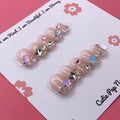 Cutesy Star press on nails by CutiePop Nail Shop featuring short squoval shaped nails in soft pastel pink and lavender tones, adorned with cute star, heart, and pearl accents for a dreamy kawaii look.

