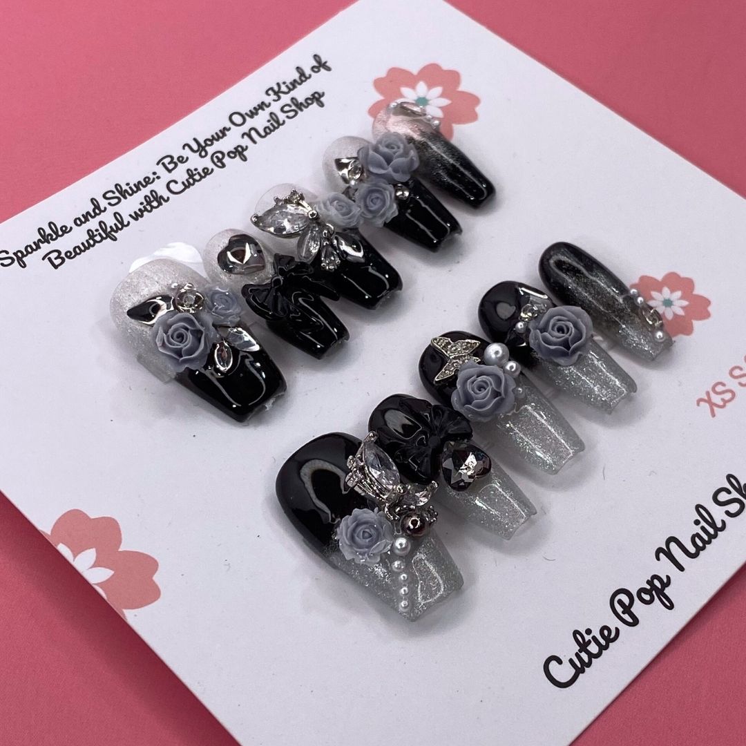 Dark Aura press on nails by CutiePop Nail Shop featuring long coffin shaped nails with a glossy black base layered with smoky gradient aura effects in deep purples and iridescent shimmer, finished with subtle metallic accents for a dramatic, gothic elegant aesthetic.

