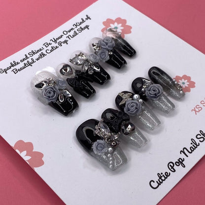 Dark Aura press on nails by CutiePop Nail Shop featuring long coffin shaped nails with a glossy black base layered with smoky gradient aura effects in deep purples and iridescent shimmer, finished with subtle metallic accents for a dramatic, gothic elegant aesthetic.


