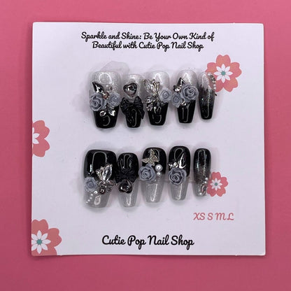 Dark Aura press on nails by CutiePop Nail Shop featuring long coffin shaped nails with a glossy black base layered with smoky gradient aura effects in deep purples and iridescent shimmer, finished with subtle metallic accents for a dramatic, gothic elegant aesthetic.

