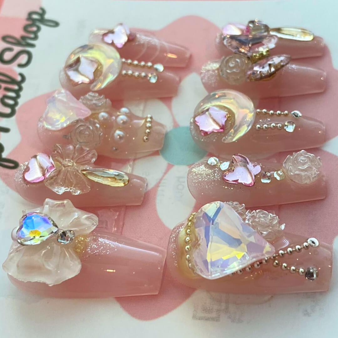 Dream Girl press‑on nails by CutiePop Nail Shop featuring short-to-medium length round or oval nails in a soft pastel palette of blush pink, lavender, mint green, and creamy white. Decorated with dreamy motifs like iridescent stars, floating hearts, subtle floral accents, and holographic shimmer. Includes adhesive tabs, mini nail file, and cuticle stick for DIY application—delivering a whimsical, youthful aesthetic perfect for pastel dreams.