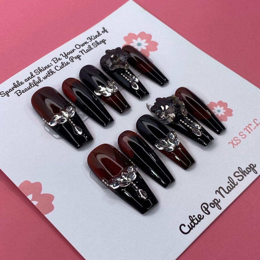 Elegant Spice press on nails by CutiePop Nail Shop featuring coffin shaped nails in warm amber and nude tones with a glossy finish and subtle gold accents for a refined, sophisticated look.

