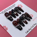 Elegant Spice press on nails by CutiePop Nail Shop featuring coffin shaped nails in warm amber and nude tones with a glossy finish and subtle gold accents for a refined, sophisticated look.

