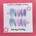 Enchanted Ombre press on nails by CutiePop Nail Shop featuring long stiletto shaped nails with a dreamy pastel ombré blend of icy blue, lavender, and soft pink tones. Accented with chunky glitter, sparkling gems, and intricate embossed details—finished in a glossy coat for a magical, whimsical aesthetic.

