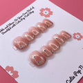 Glittery Blush press on nails by CutiePop Nail Shop featuring short squoval shaped nails in soft blush pink tones with a glittery, shimmering finish for a subtle yet elegant sparkle.

