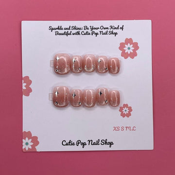 Glittery Blush press on nails by CutiePop Nail Shop featuring short squoval shaped nails in soft blush pink tones with a glittery, shimmering finish for a subtle yet elegant sparkle.

