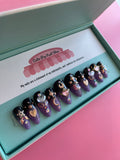 Cosmic Moon – Saturn press on nails by CutiePop Nail Shop featuring medium almond shaped nails with a hand painted black to purple ombré, finished in high reflective fine glitter gel polish. Inspired by Sailor Moon aesthetics, this dramatic celestial design is topped with a glossy shine for an enchanting, spacey effect.

