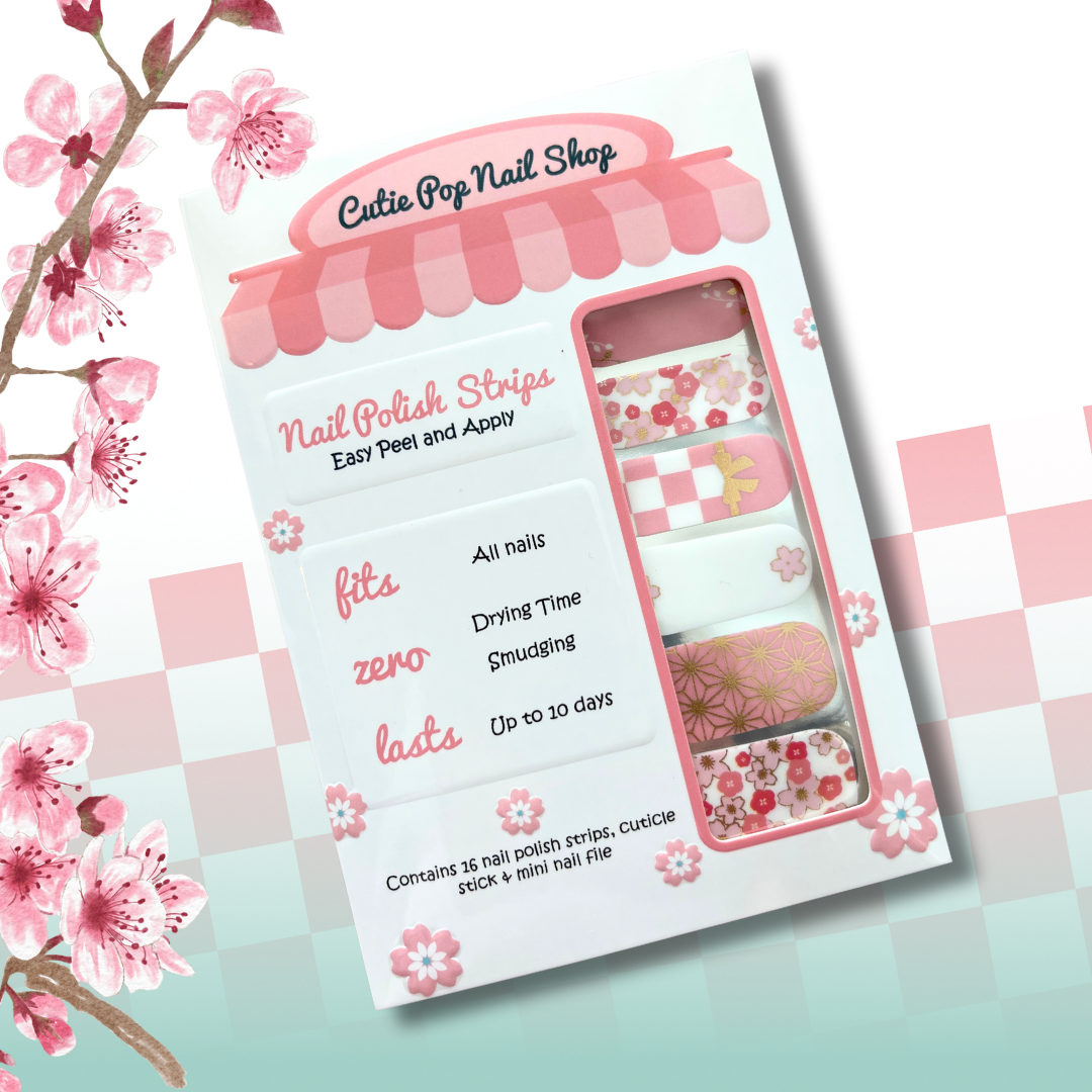 Sakura nail strips inspired by Nezuko from Demon Slayer, featuring soft pink and light blue tones with cherry blossom sakura patterns, delicate gold foil accents, and subtle anime-inspired motifs that capture Nezuko’s gentle yet fierce spirit.