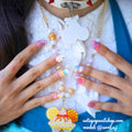 Kawaii Bunny Pastel Rainbow press-on nails by CutiePop Nail Shop featuring medium-length round/oval nails in a mix of soft pastel hues—baby pink, lavender, mint green, and pale yellow—with whimsical hand-painted bunny faces, cloud and rainbow motifs, heart and star accents over a dreamy gradient. Comes as a full DIY-ready kit including ten reusable handmade nails, jelly adhesive tabs, a mini nail file, and a cuticle stick—perfect for a bright, cute-and-playful kawaii-inspired manicure.
