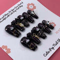 Kuromicore press on nails by CutiePop Nail Shop inspired by Kuromi, featuring medium coffin shaped nails in black and pink tones with cute gothic elements like hearts, skulls, and bows for a playful yet edgy look.



