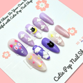 Set of purple and pink nail art designs on a white card with 'Cutie Pop Nail Shop' branding.