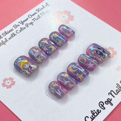 Usagi Stars press on nails by CutiePop Nail Shop featuring short squoval shaped nails in a kawaii-inspired color palette of soft pastel pinks, baby blue, and lavender. Adorned with hand-painted or foil motifs of crescent moons, stars, and rabbit-themed accents (like bunny ears or silhouettes), and finished with a glossy gel polish for dreamy, whimsical magic.