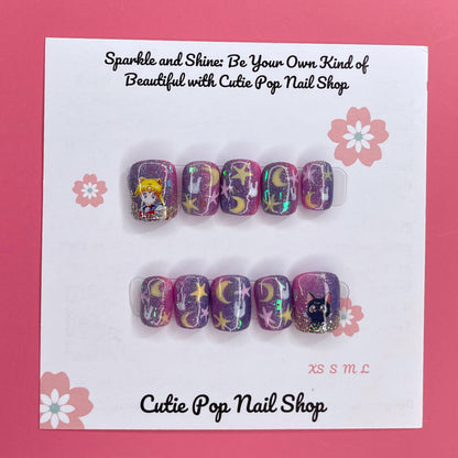 Usagi Stars press on nails by CutiePop Nail Shop featuring short squoval shaped nails in a kawaii-inspired color palette of soft pastel pinks, baby blue, and lavender. Adorned with hand-painted or foil motifs of crescent moons, stars, and rabbit-themed accents (like bunny ears or silhouettes), and finished with a glossy gel polish for dreamy, whimsical magic.