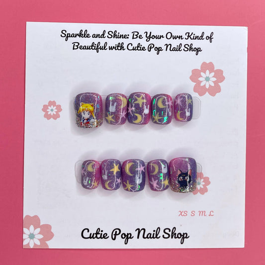 Usagi Stars press on nails by CutiePop Nail Shop featuring short squoval shaped nails in a kawaii-inspired color palette of soft pastel pinks, baby blue, and lavender. Adorned with hand-painted or foil motifs of crescent moons, stars, and rabbit-themed accents (like bunny ears or silhouettes), and finished with a glossy gel polish for dreamy, whimsical magic.