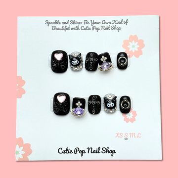 Short Kuromi press-on nails in a compact length with a soft color base, featuring 3D Kuromi character charms and cute kawaii-style accents, finished with a glossy shine – displayed on a Cutie Pop Nail Shop card.