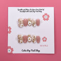 Spring Flowers press-on nails by CutiePop Nail Shop featuring medium-length round-shaped nails in soft pastel tones, adorned with hand-painted floral designs, pearl or gem accents, and a fresh, springtime aesthetic perfect for a cheerful, blooming look.


