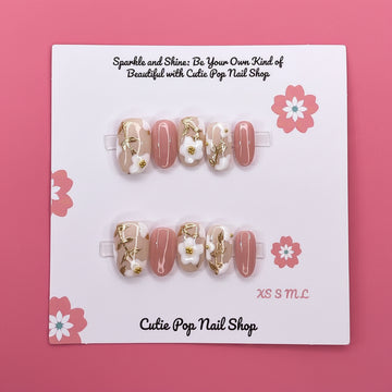 Spring Flowers press-on nails by CutiePop Nail Shop featuring medium-length round-shaped nails in soft pastel tones, adorned with hand-painted floral designs, pearl or gem accents, and a fresh, springtime aesthetic perfect for a cheerful, blooming look.

