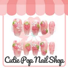 Sweet Strawberry press on nails by CutiePop Nail Shop featuring medium coffin shaped nails with a playful mix of soft pink and strawberry red tones, adorned with charming strawberry decals, dainty white dots, and glossy finishes. Perfect for a sweet, kawaii-inspired look with a fresh, fruity twist.