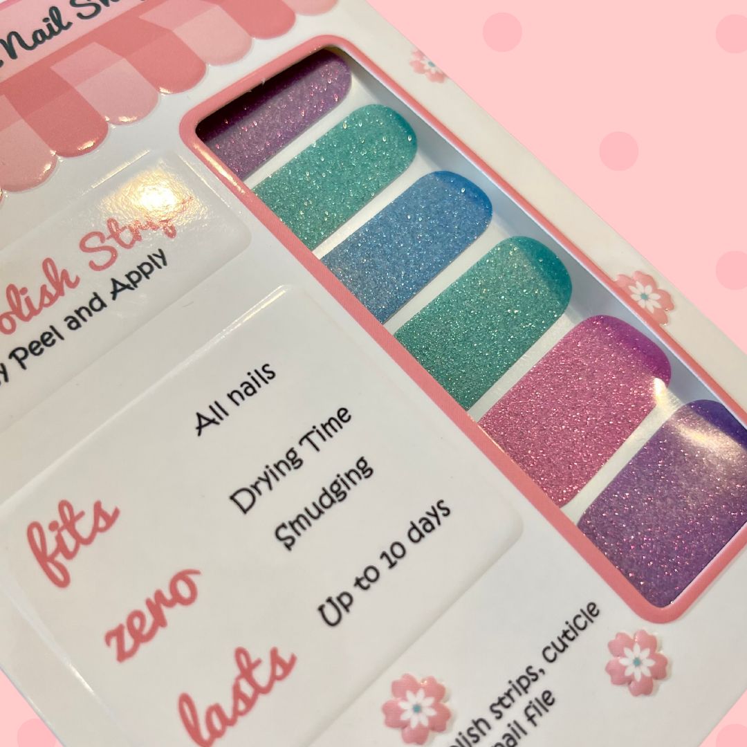 Multicolor Solid Glitter nail polish strips by Cutie Pop Nail Shop featuring shimmering solid shades in lavender, teal, blue, and pink tones with a smooth glitter finish, displayed in a pink-edged packaging labeled "Peel and Apply" and "Up to 10 days.