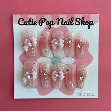 Sweet Moon Guardian press-on nails by CutiePop Nail Shop featuring medium-length coffin-shaped nails in soft pastel tones with dreamy moon and star motifs. Accented with glitter, tiny heart decals, and Sailor Moon-inspired elements, this magical set evokes a sweet celestial vibe. Includes 10 reusable handmade nails, jelly adhesive tabs, mini nail file, and cuticle stick—perfect for moonlit transformations and kawaii fans alike.
