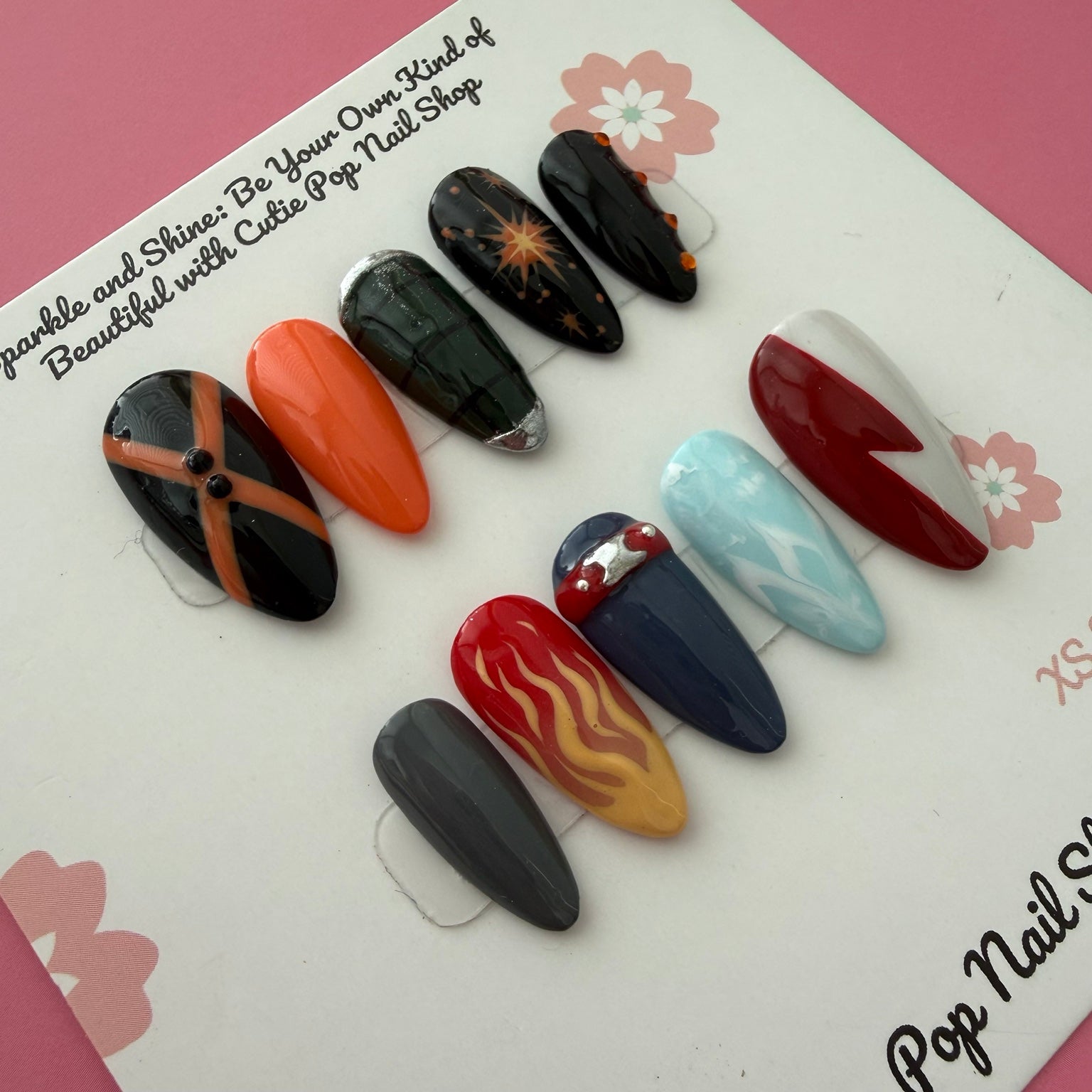 Close-up of MHA BKA anime-inspired medium almond press-on nails with hero character color details