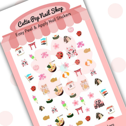 This image showcases Cutie Pop Nail Shop’s Nihon nail decals against a white background with a Cutie Pop Nail Shop logo and watermark. Designs include a bowl of ramen, a Japanese lantern, a neko and tengu mask, cherry blossom, yin-yang-style circling fish, multicolored fish caught on a line, hanami dango, temple gates, sushi, and waving cats.